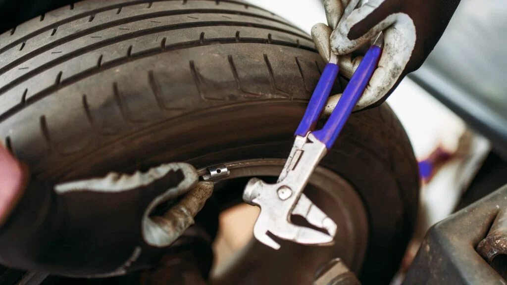 Balancing tires using a computerized machine in the shop